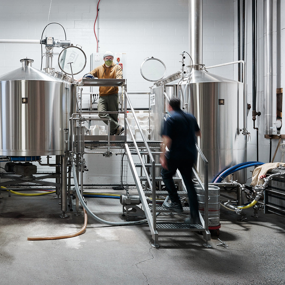 two brewers making beer