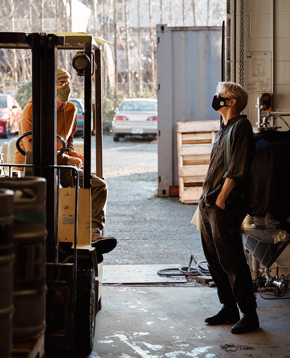 two employees hanging out in the moody ales warehouse