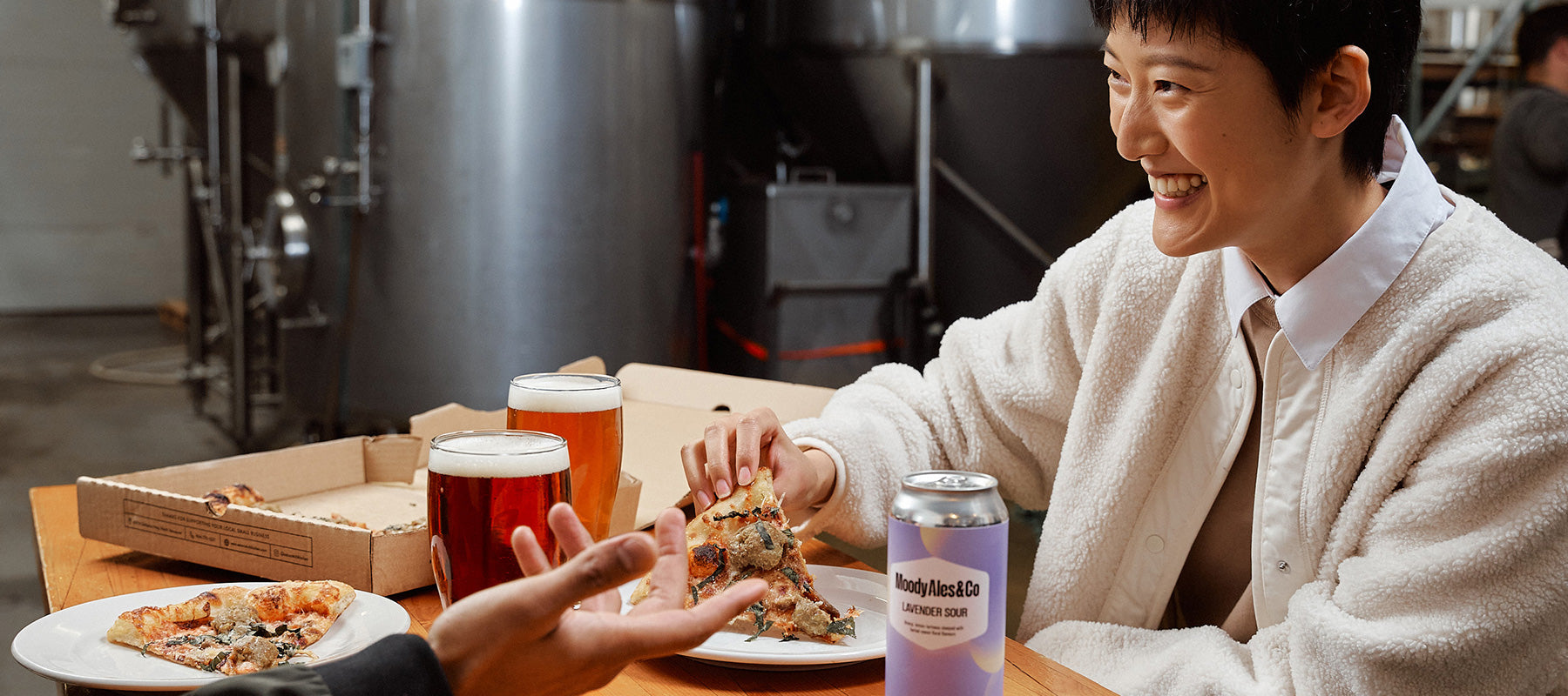 girl holding pizza with beer