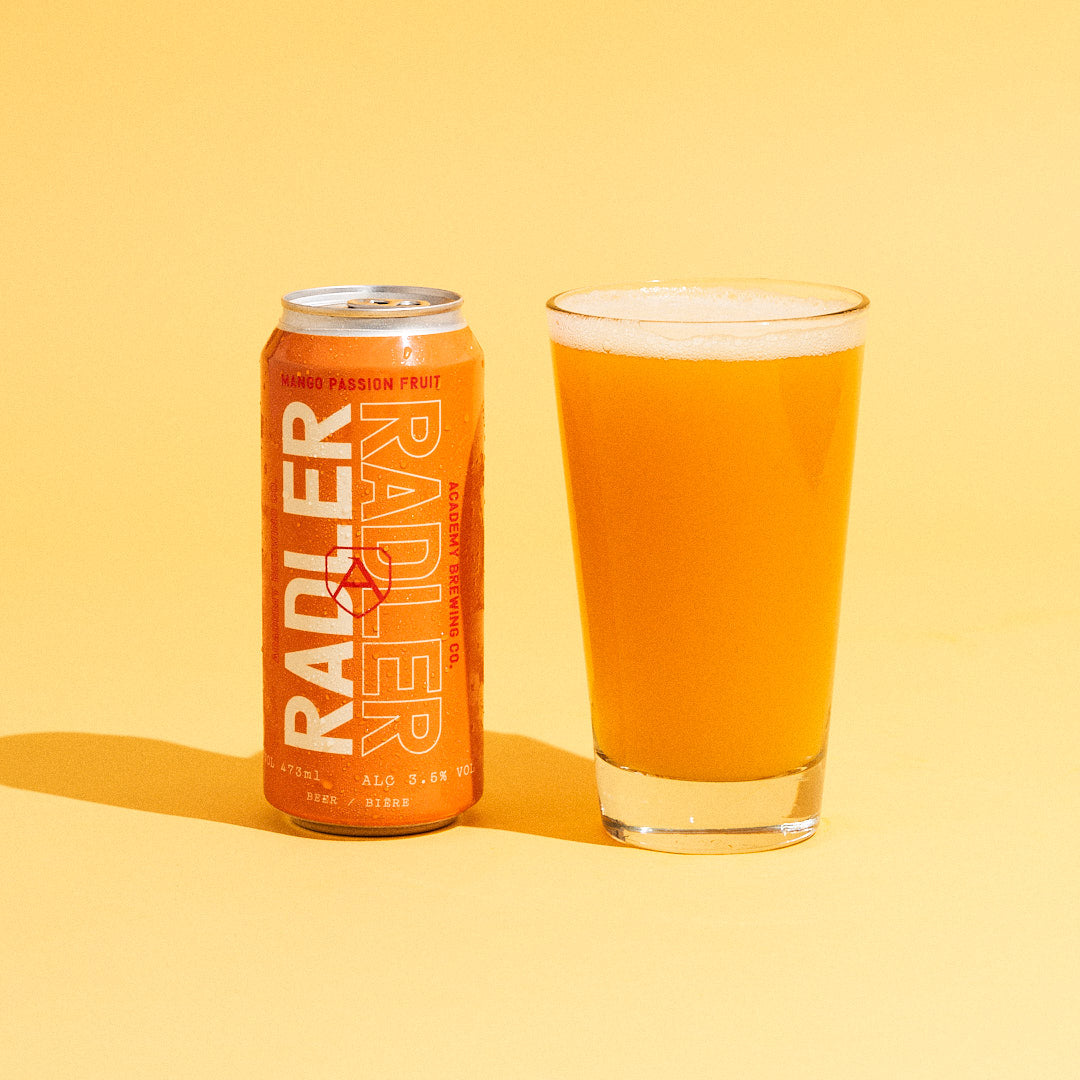 Academy brewing mango radler can with drink in glass