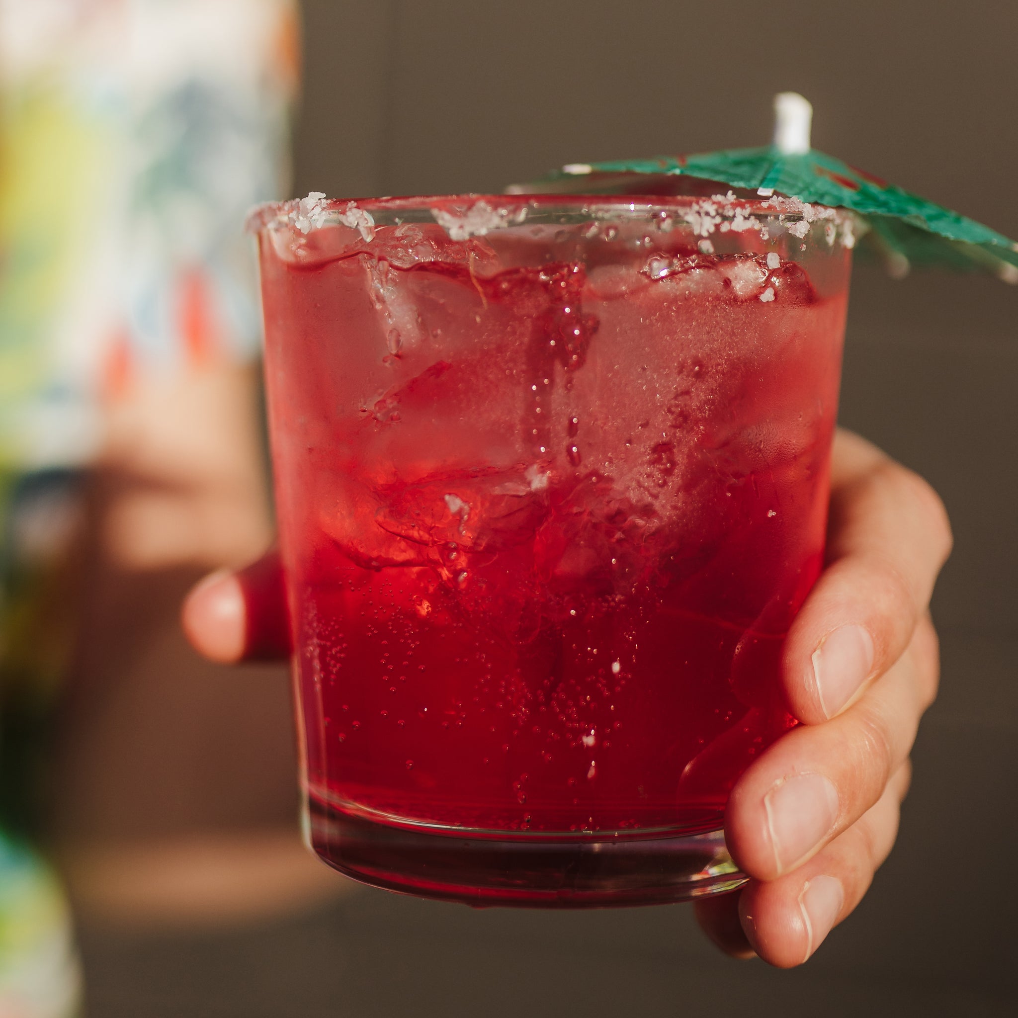 strawberry margarita with umbrella in it