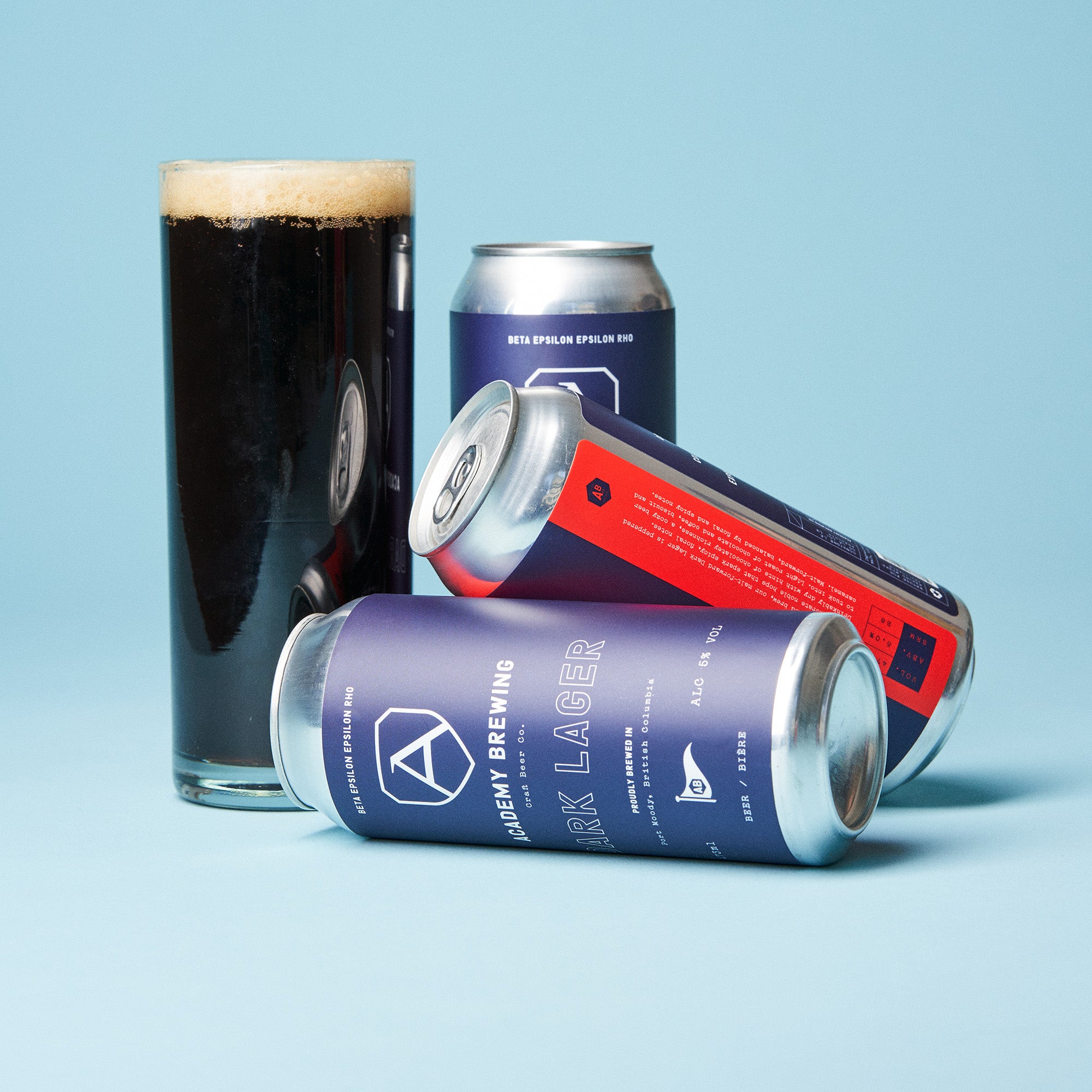 academy brewing dark lager cans with drink in glass