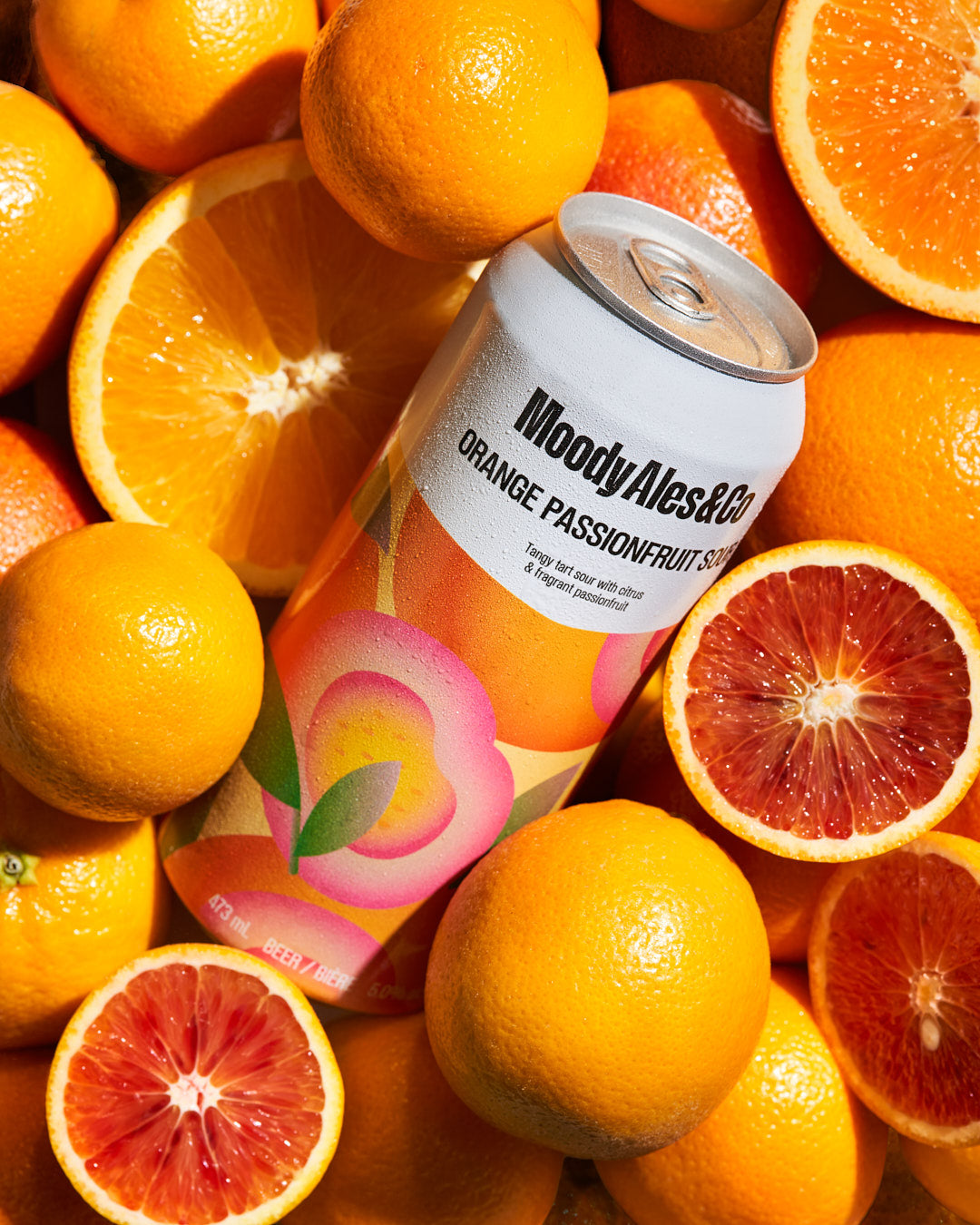 orange passionfruit sour can amongst oranges